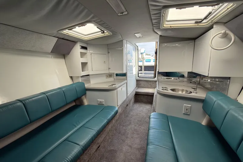 Slide: The Image of Interior of 1995 Formula 382 SR-1 boat with teal seating and compact kitchenette. - 14