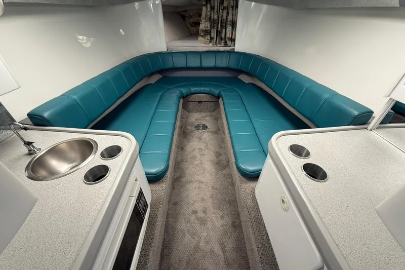 Slide: The Image of Interior of 1995 Formula 382 SR-1 boat with teal seating and kitchenette. - 15