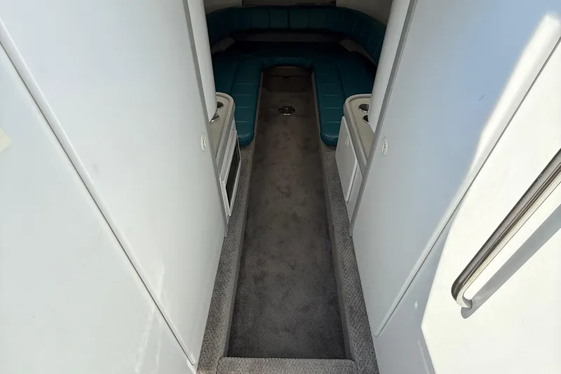 Slide: The Image of Interior of a 1995 Formula 382 SR-1 boat with teal seating and carpeted floor. - 17