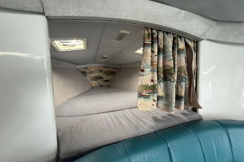 Slide: The Image of Interior cabin of a 1995 Formula 382 SR-1 boat with nautical-themed curtains. - 19