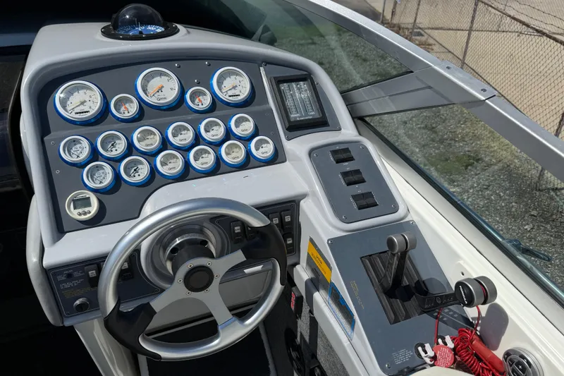 Slide: The Image of 1995 Formula 382 SR-1 boat dashboard with gauges, steering wheel, and controls. - 23