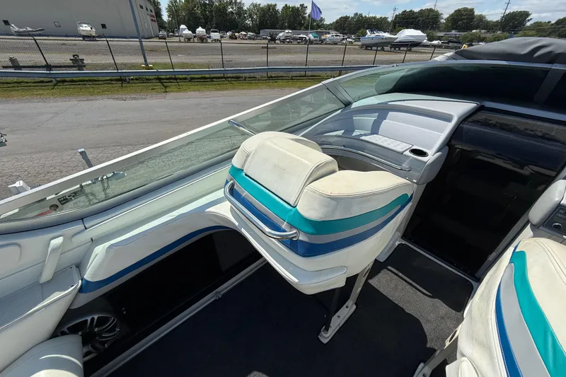 Slide: The Image of 1995 Formula 382 SR-1 boat interior with white and blue seating, docked outdoors. - 27