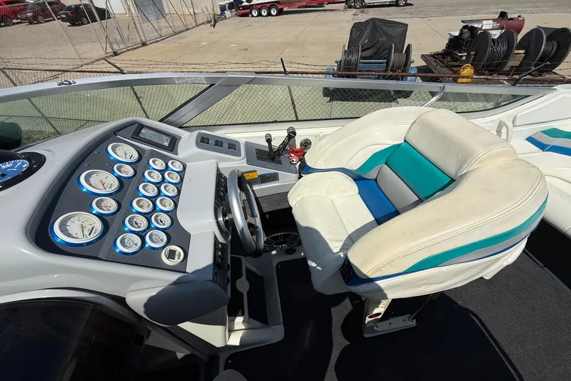 Slide: The Image of Cockpit of a 1995 Formula 382 SR-1 boat with gauges and white seating. - 28