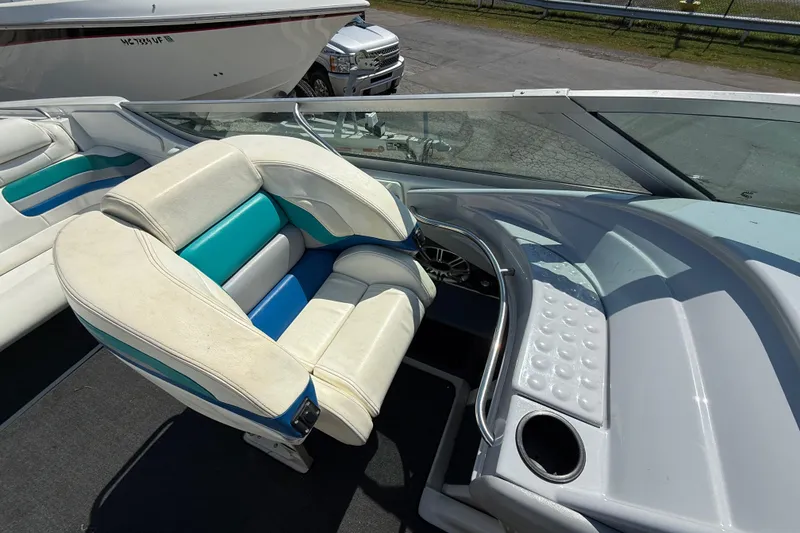 Slide: The Image of 1995 Formula 382 SR-1 boat interior with white and teal seating, dashboard, and cup holder. - 29