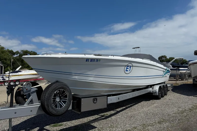 Slide: The Image of 1995 Formula 382 SR-1 speedboat on trailer under clear blue sky. - 3