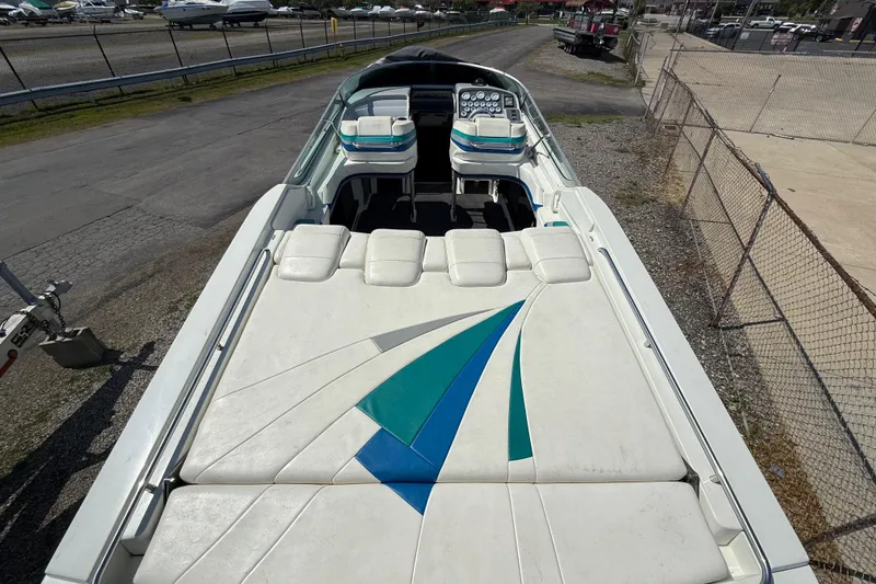 Slide: The Image of 1995 Formula 382 SR-1 boat with white and teal upholstery, docked on a paved area. - 34
