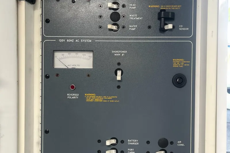 Slide: The Image of Control panel of a 1995 Formula 382 SR1 boat, featuring AC system and switches. - 40