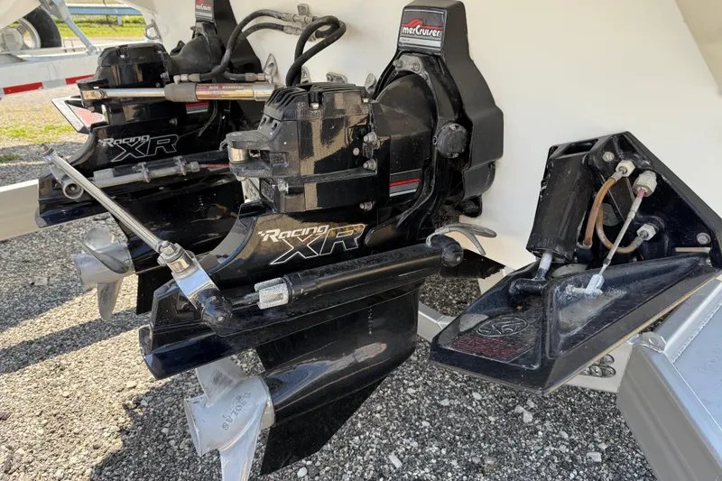 Slide: The Image of 1995 Formula 382 SR-1 boat with MerCruiser Racing XR outdrives, parked on gravel. - 5