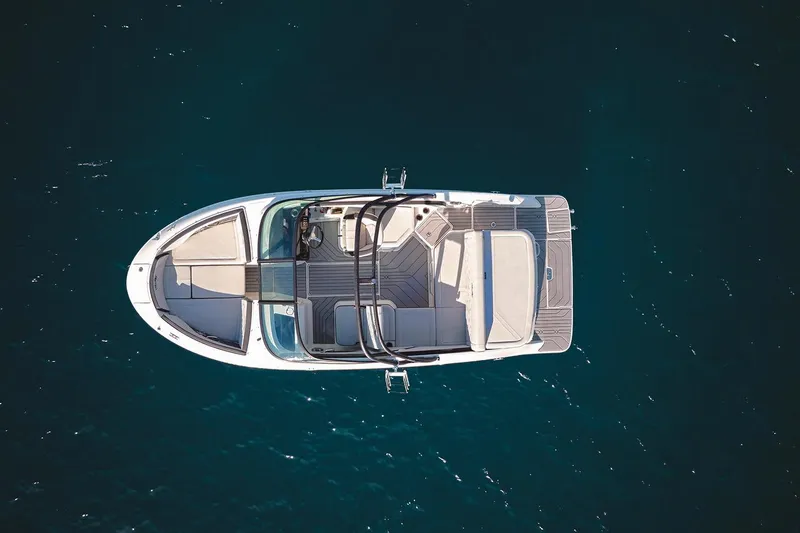 Slide: The Image of 2026 Sea Ray SPX 210 boat with spacious seating in a showroom. - 3