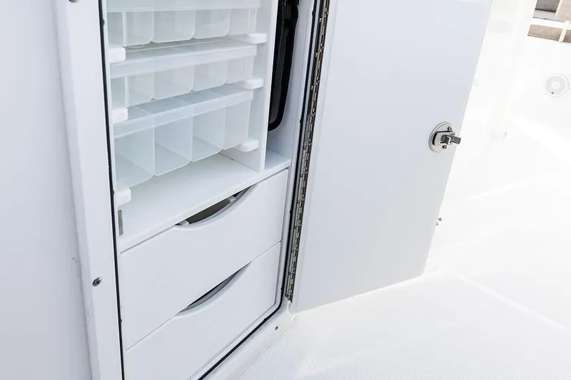 Slide: The Image of 2026 Sea Hunt Ultra 229 boat interior with white cushioned seating and stainless steel fixtures. - 10