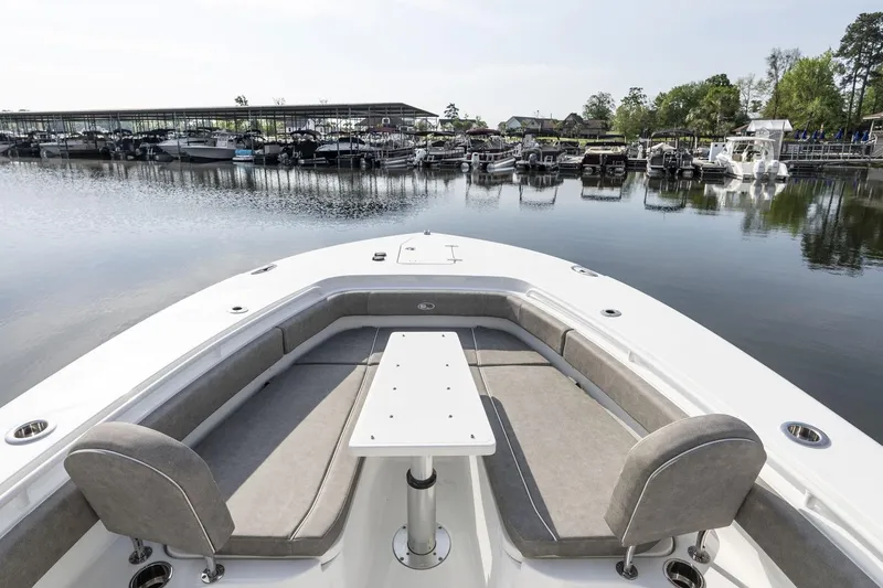 Slide: The Image of 2026 Sea Hunt Ultra 229 boat interior with white seating and helm station. - 12