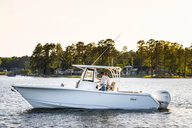 The Image of 2026 Sea Hunt Ultra 229 boat displayed at an indoor boat show. - 2
