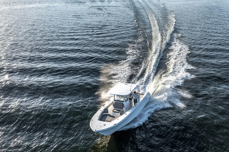 Slide: The Image of 2026 Sea Hunt Ultra 229 boat with Yamaha 200 engine displayed indoors. - 4