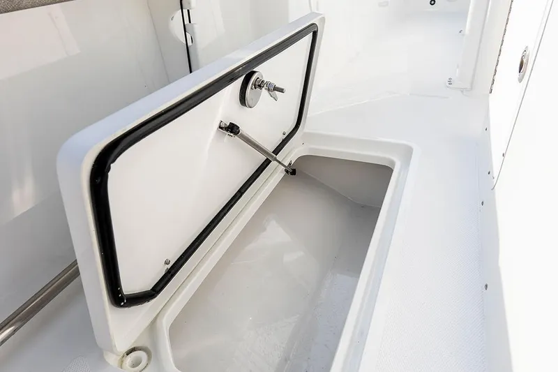 Slide: The Image of 2026 Sea Hunt Ultra 229 boat interior with white cushioned seating and steering wheel. - 9