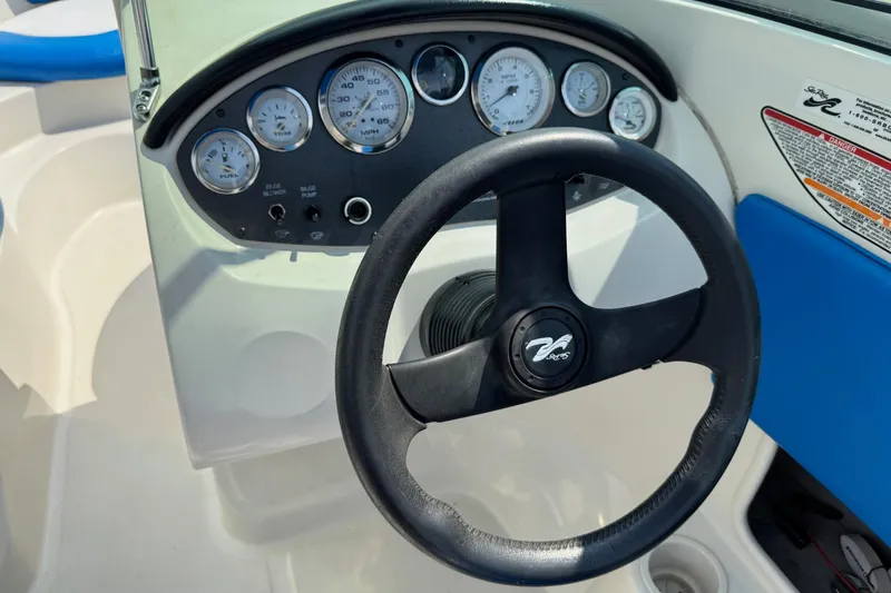 Slide: The Image of Steering wheel and dashboard of 2007 Sea Ray 195 Sport boat, featuring gauges and controls. - 14