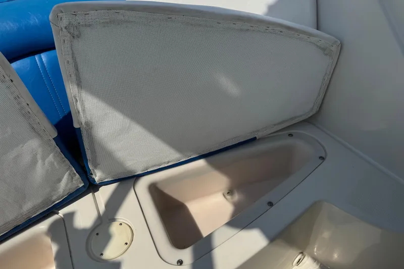 Slide: The Image of 2007 Sea Ray 195 Sport boat interior storage compartment with blue and white seating. - 17