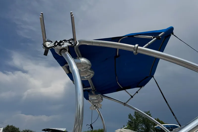 Slide: The Image of 2007 Sea Ray 195 Sport boat with blue canopy against cloudy sky. - 5