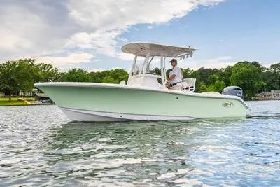 Slide: The Image of 2026 Sea Hunt Ultra 219 boat cruising on a serene lake. - 1