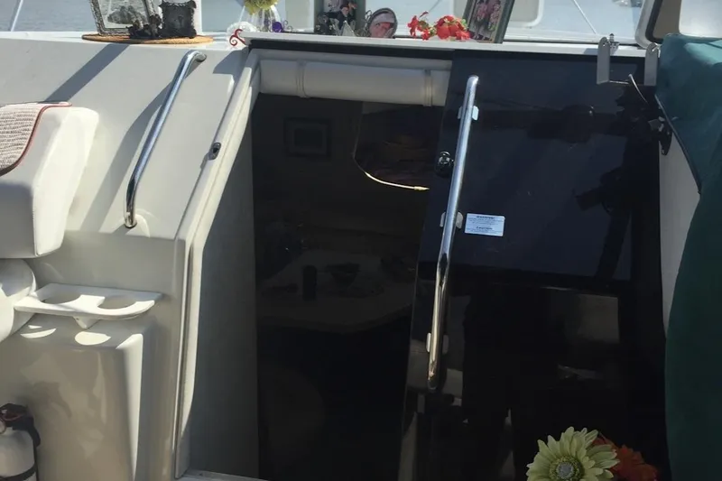 Slide: The Image of 1993 Silverton 34 Express boat interior with open cabin door and seating area. - 4