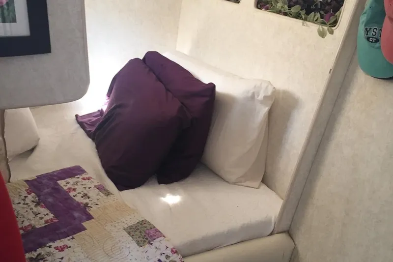 Slide: The Image of Cozy cabin interior of 1993 Silverton 34 Express with pillows and quilted bedding. - 8