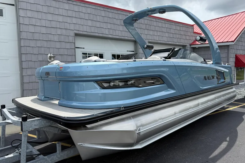 Slide: The Image of 2026 Avalon 2585 Excalibur Tri-toon boat with Mercury 400hp V-10 engine, blue exterior. - 2