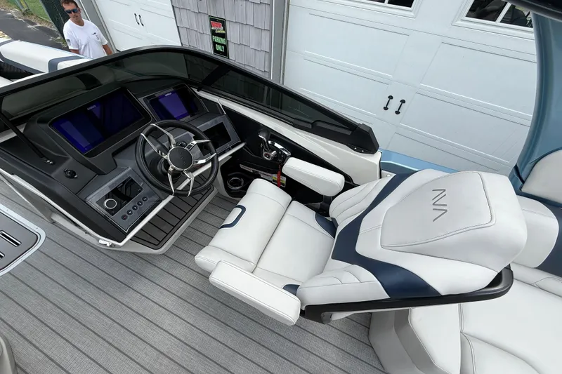 Slide: The Image of Interior of 2026 Avalon 2585 Excalibur boat with modern dashboard and luxurious seating. - 23