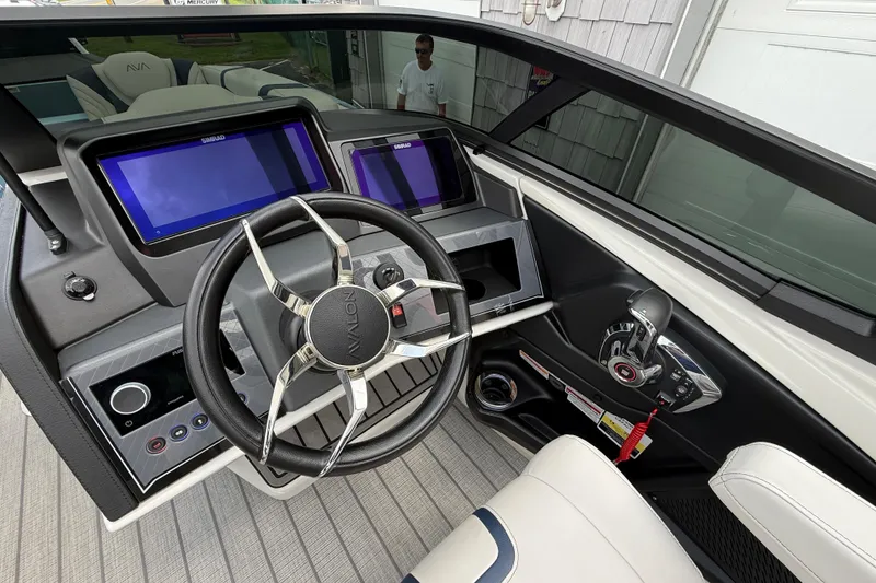 Slide: The Image of Interior of 2026 Avalon 2585 Excalibur boat with modern dashboard and steering wheel. - 25