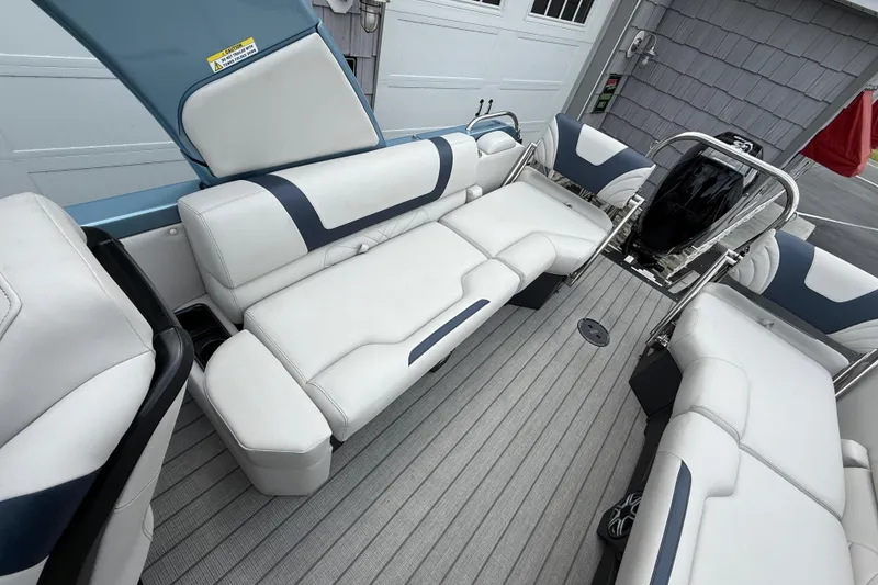 Slide: The Image of 2026 Avalon 2585 Excalibur boat interior with white seating and Mercury 400hp V-10 engine. - 31