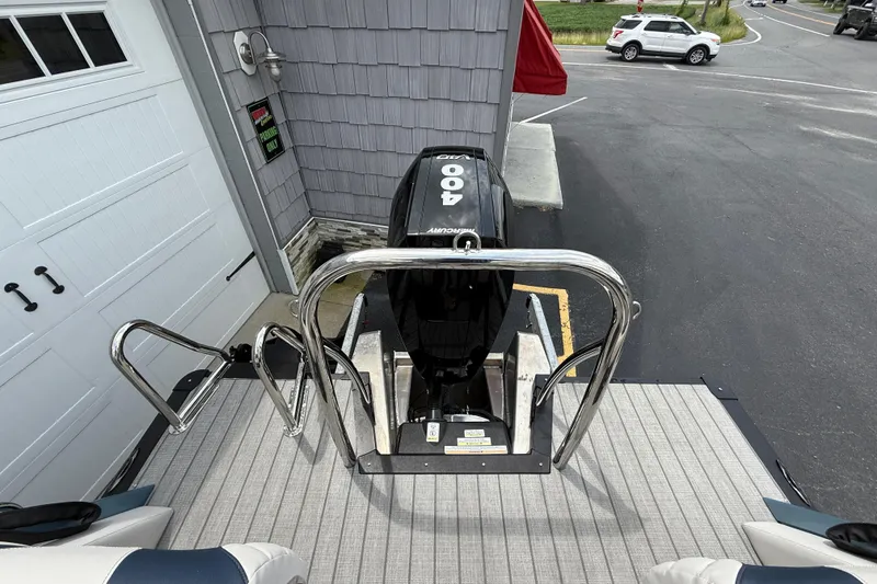 Slide: The Image of 2026 Avalon 2585 Excalibur boat with Mercury 400hp V-10 engine, docked near a garage. - 39