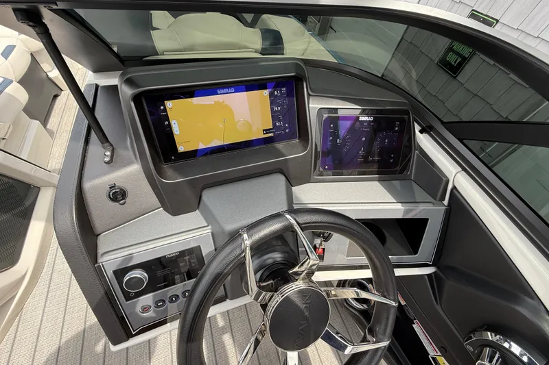 Slide: The Image of 2026 Avalon 2585 Excalibur boat dashboard with advanced navigation displays and controls. - 41