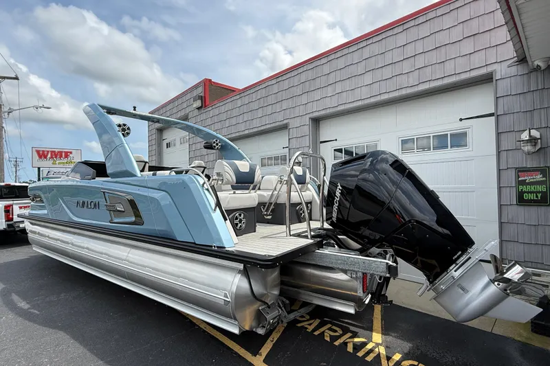 Slide: The Image of 2026 Avalon 2585 Excalibur pontoon boat with Mercury 400hp V-10 engine, parked outside. - 6