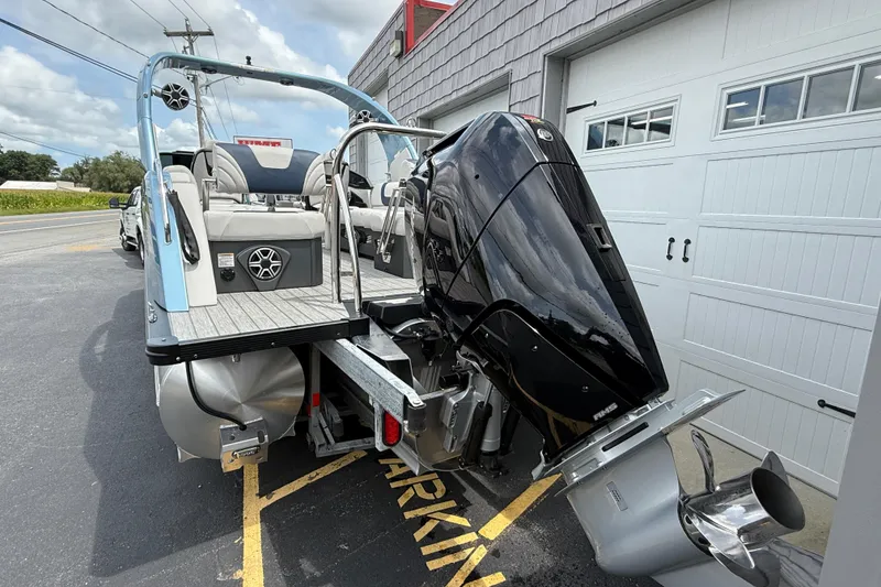 Slide: The Image of 2026 Avalon 2585 Excalibur boat with Mercury 400hp V-10 engine, parked outdoors. - 7