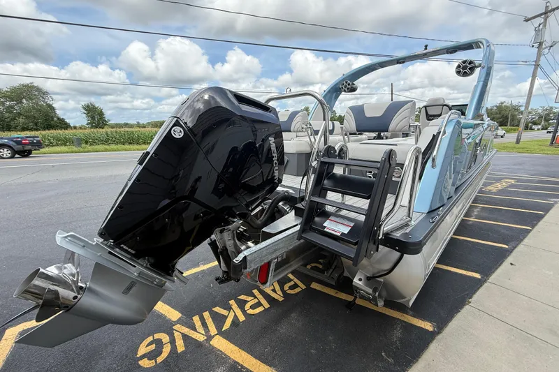 Slide: The Image of 2026 Avalon 2585 Excalibur boat with Mercury 400hp V-10 engine, parked outdoors. - 8