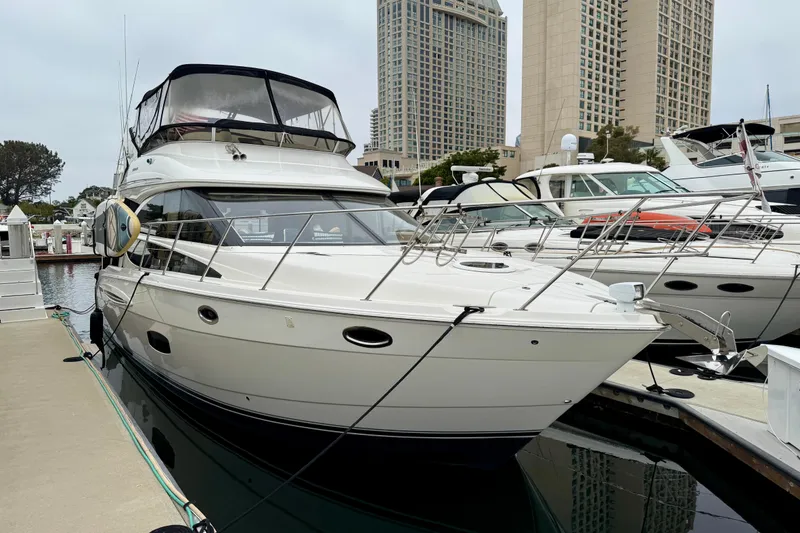 The Image of 2014 Meridian 391 Sedan yacht docked at marina with cityscape background. - 0