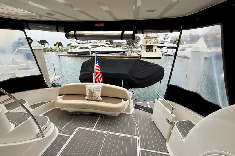Slide: The Image of 2014 Meridian 391 Sedan yacht interior with seating, docked at marina. - 10
