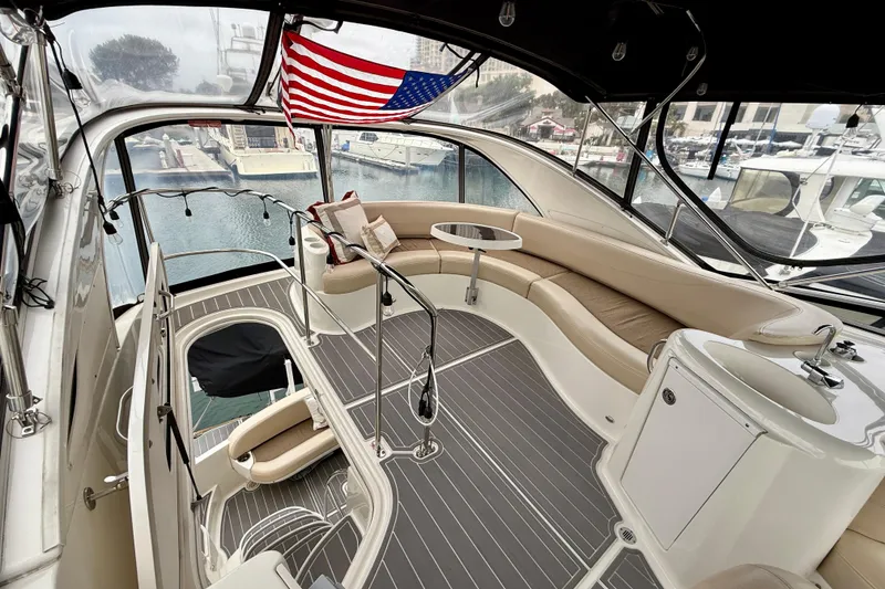 Slide: The Image of 2014 Meridian 391 Sedan yacht interior with seating, table, and American flag. - 11
