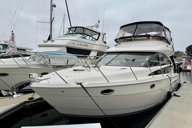 Slide: The Image of 2014 Meridian 391 Sedan yacht docked at marina, showcasing sleek design and luxury features. - 2