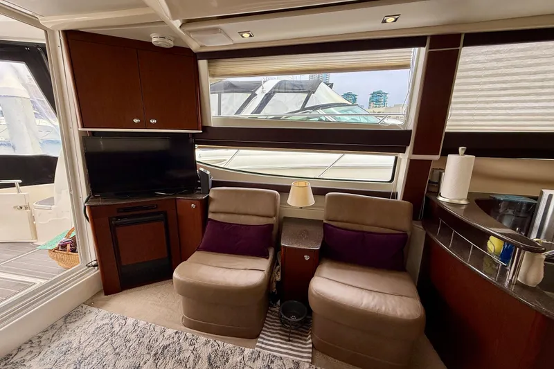 Slide: The Image of Luxurious interior of 2014 Meridian 391 Sedan yacht with seating, TV, and window view. - 23