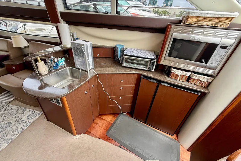 Slide: The Image of 2014 Meridian 391 Sedan yacht kitchen with sink, microwave, and storage cabinets. - 28