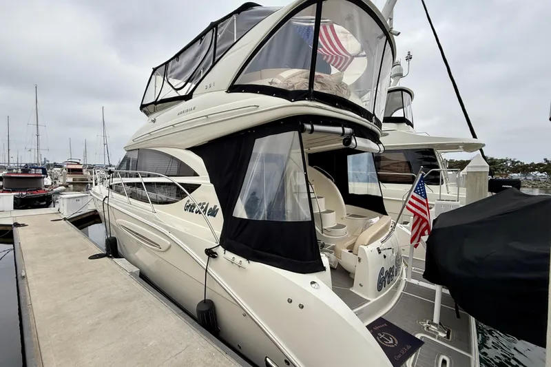 Slide: The Image of 2014 Meridian 391 Sedan yacht docked at marina with American flag. - 3