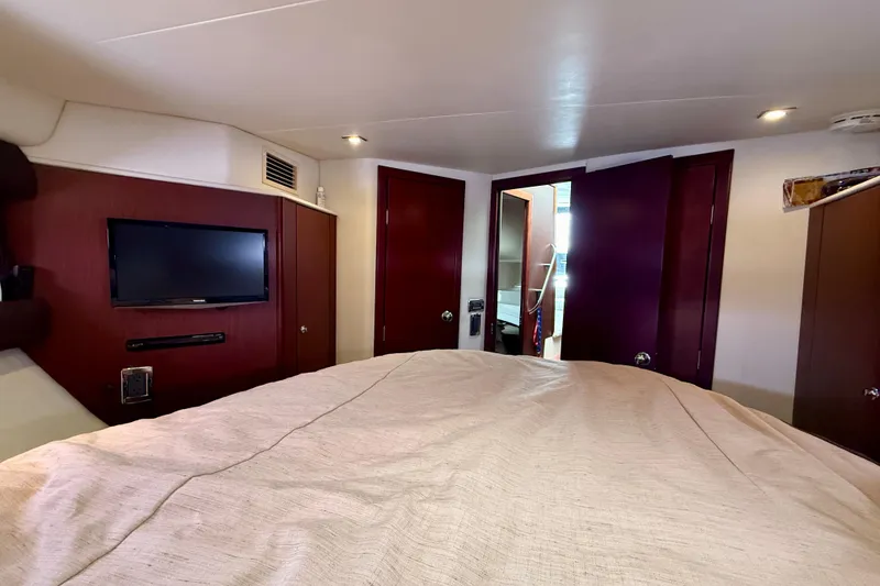 Slide: The Image of Interior of 2014 Meridian 391 Sedan yacht bedroom with TV and wooden cabinetry. - 33