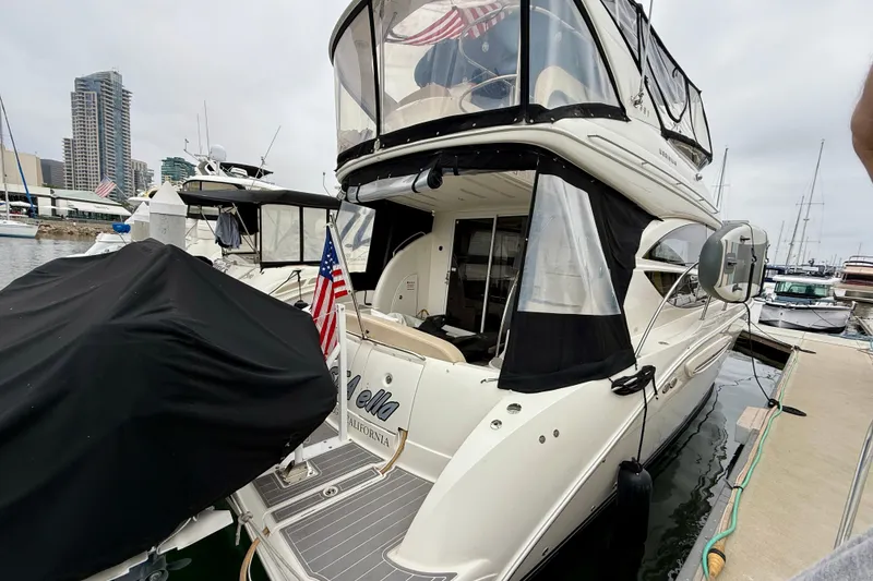 Slide: The Image of 2014 Meridian 391 Sedan yacht docked in marina, featuring sleek design and American flag. - 4