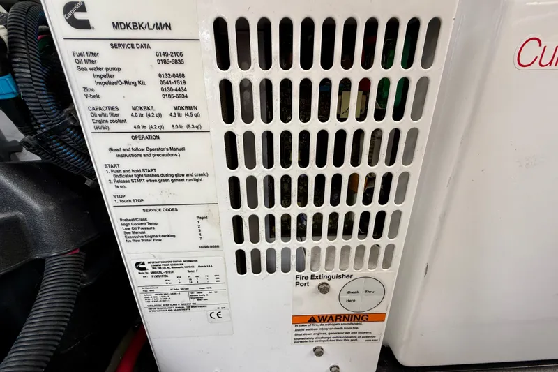 Slide: The Image of Engine compartment of a 2014 Meridian 391 Sedan with service data and warning labels. - 40