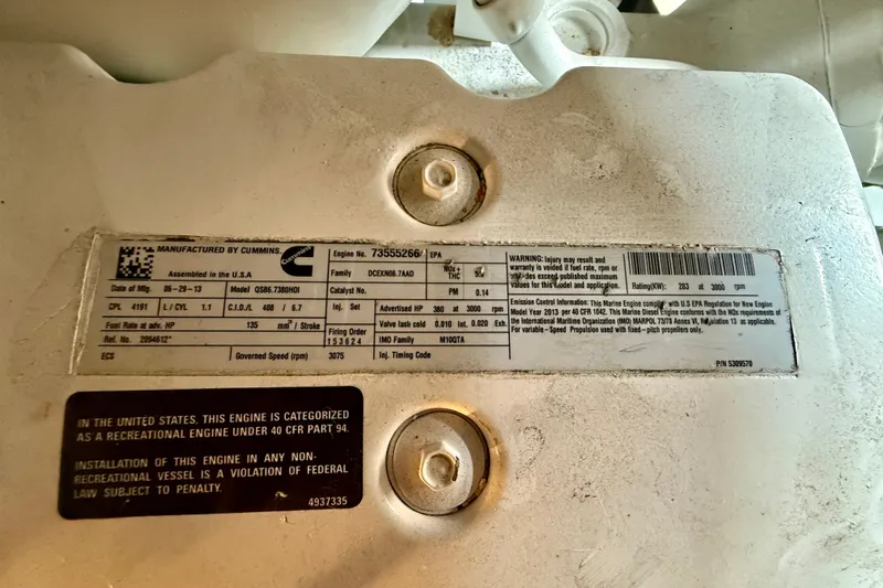 Slide: The Image of Engine label on 2014 Meridian 391 Sedan, featuring Cummins specifications and warnings. - 54