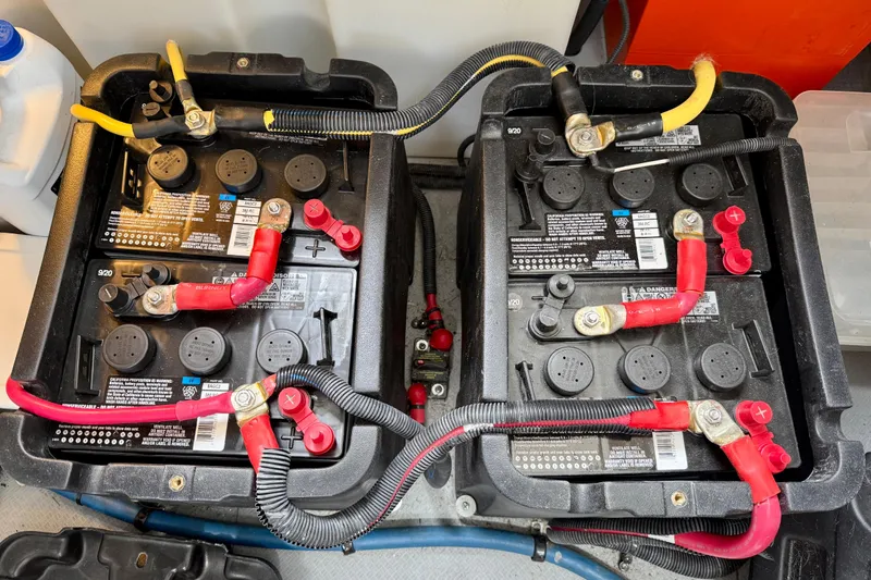 Slide: The Image of Two connected marine batteries in a 2014 Meridian 391 Sedan engine compartment. - 58