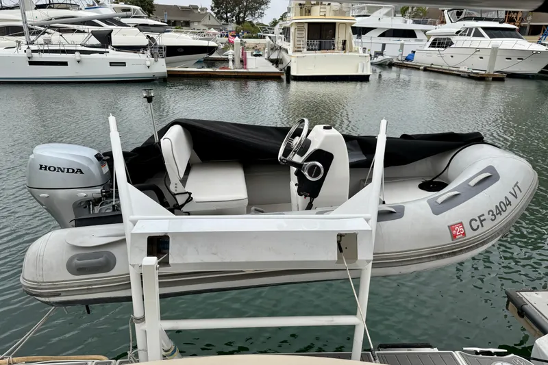 Slide: The Image of Inflatable boat with Honda motor docked near luxury yachts, Meridian 391 Sedan, 2014 model. - 6