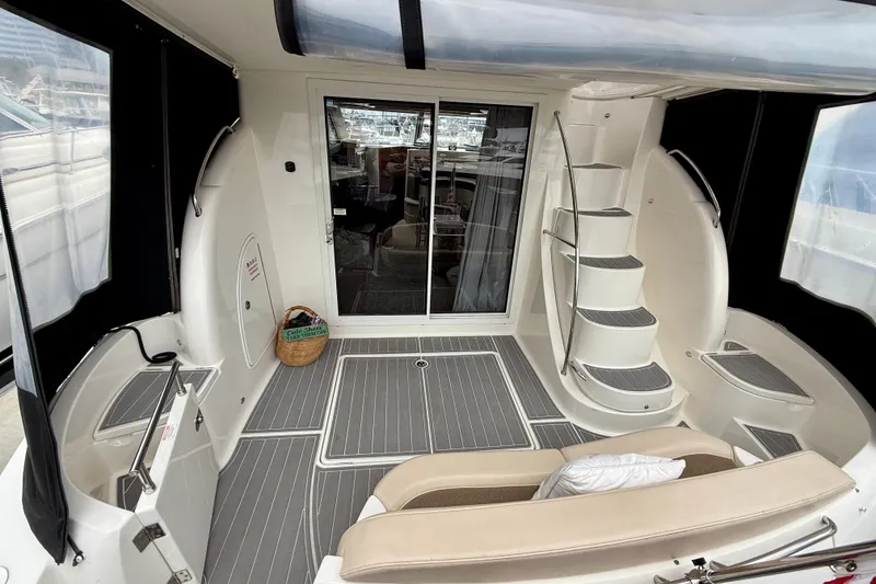 Slide: The Image of 2014 Meridian 391 Sedan yacht interior with spiral staircase and seating area. - 9