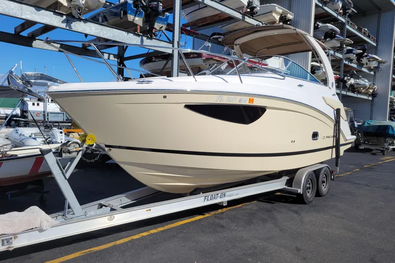 The Image of 2018 Regal 26 Express boat on trailer in marina storage area. - 0