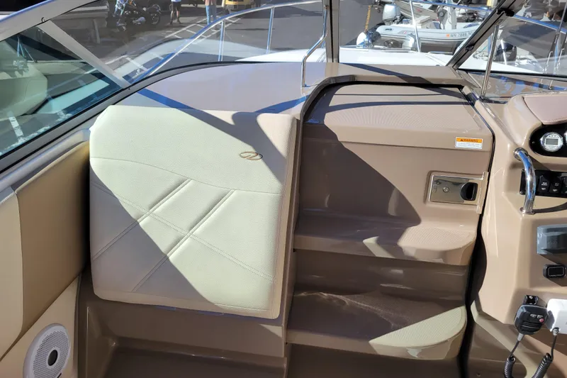 Slide: The Image of 2018 Regal 26 Express boat interior with beige seating and control panel. - 10