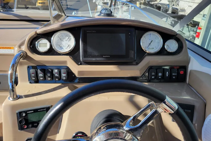 Slide: The Image of 2018 Regal 26 Express boat dashboard with steering wheel and navigation controls. - 12
